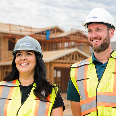ACU Member Qualico - Individuals in front of homes under construction